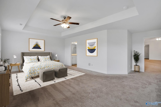 2452 Belltown Dr, Huntsville, AL 35803 - carpeted bedroom featuring a raised ceiling, baseboards, ceiling fan, and ensuite bath
