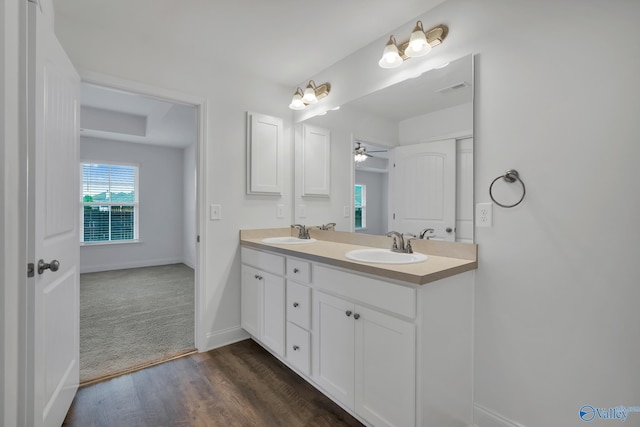 2452 Belltown Dr, Huntsville, AL 35803 - bathroom featuring a ceiling fan, wood finished floors, baseboards, and double vanity