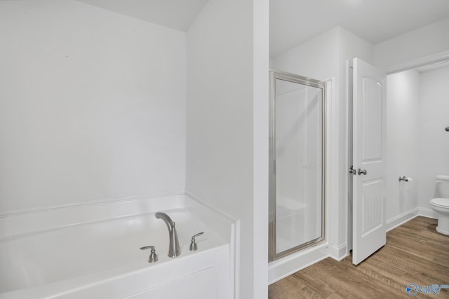 2452 Belltown Dr, Huntsville, AL 35803 - bathroom with toilet, a stall shower, wood finished floors, and a garden tub