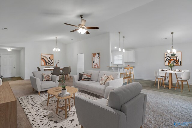 2452 Belltown Dr, Huntsville, AL 35803 - living area with a chandelier, lofted ceiling, a ceiling fan, and baseboards