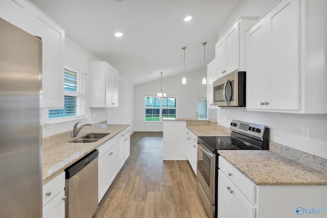 2452 Belltown Dr, Huntsville, AL 35803 - kitchen with appliances with stainless steel finishes, a sink, light wood-type flooring, lofted ceiling, and plenty of natural light