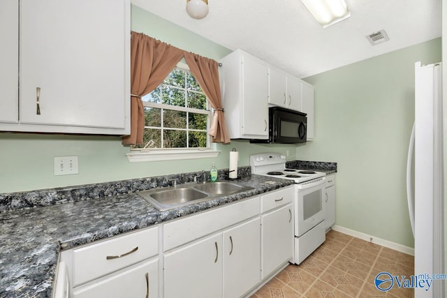 249 Knox Creek Trl NW, Madison, AL 35757 - kitchen with white appliances, dark countertops, white cabinets, and light tile patterned flooring