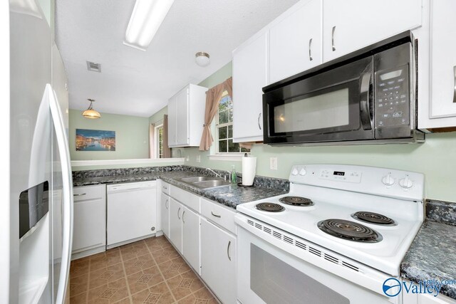 249 Knox Creek Trl NW, Madison, AL 35757 - kitchen with white appliances, white cabinets, dark countertops, and light tile patterned floors