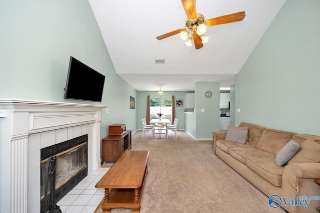 249 Knox Creek Trl NW, Madison, AL 35757 - living area with a tile fireplace, ceiling fan, light carpet, and lofted ceiling