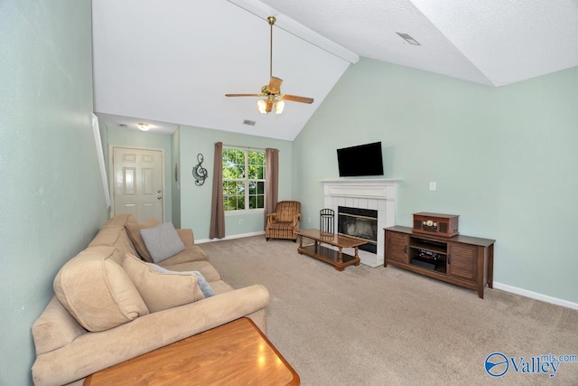 249 Knox Creek Trl NW, Madison, AL 35757 - carpeted living room featuring a ceiling fan, a tiled fireplace, beam ceiling, and high vaulted ceiling