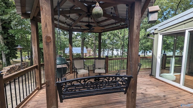 wooden deck with a gazebo and ceiling fan