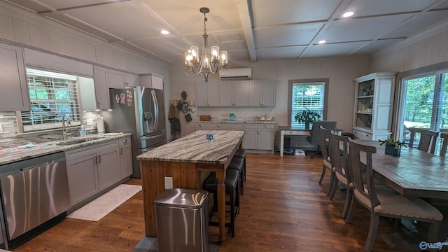 kitchen featuring a notable chandelier, appliances with stainless steel finishes, sink, coffered ceiling, and dark hardwood / wood-style floors