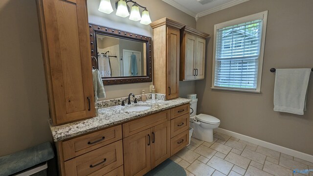 bathroom featuring toilet, tile patterned floors, vanity, and ornamental molding