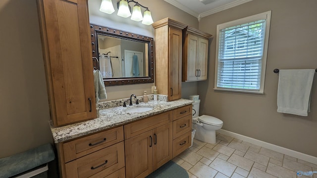 bathroom with baseboards, toilet, stone finish floor, crown molding, and vanity