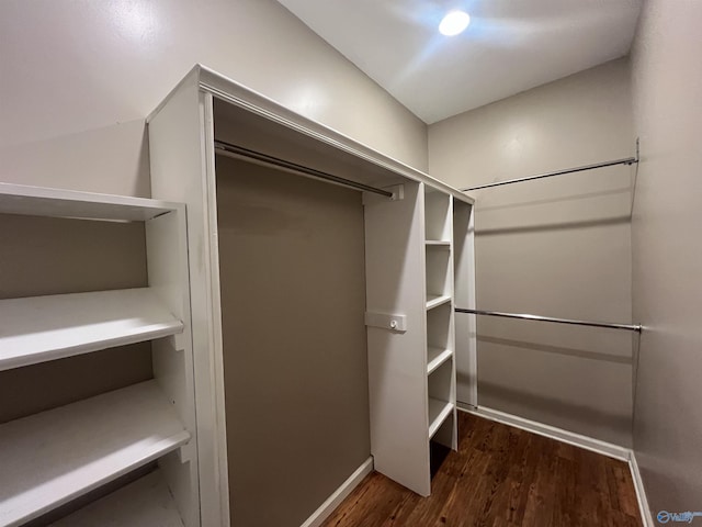 walk in closet with wood finished floors