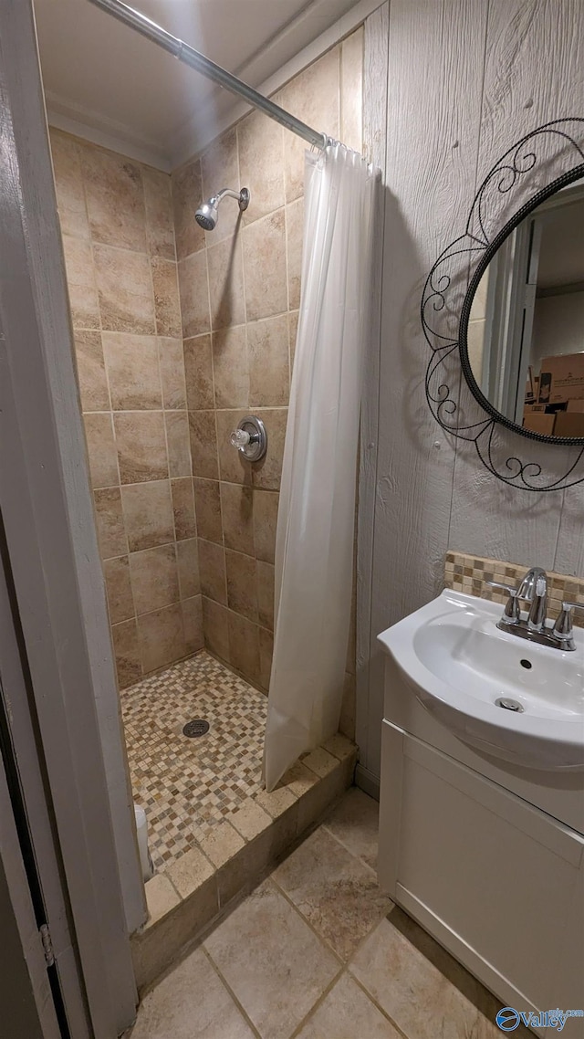 full bathroom with a stall shower, backsplash, and vanity