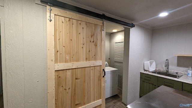 interior space with hardwood / wood-style floors, sink, and washer / dryer