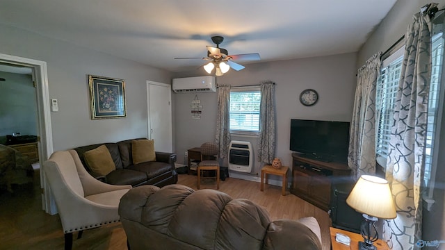 living room featuring ceiling fan, wood-type flooring, and an AC wall unit