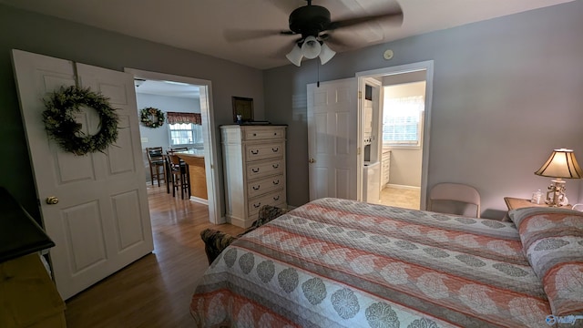 bedroom featuring ceiling fan, connected bathroom, and wood-type flooring