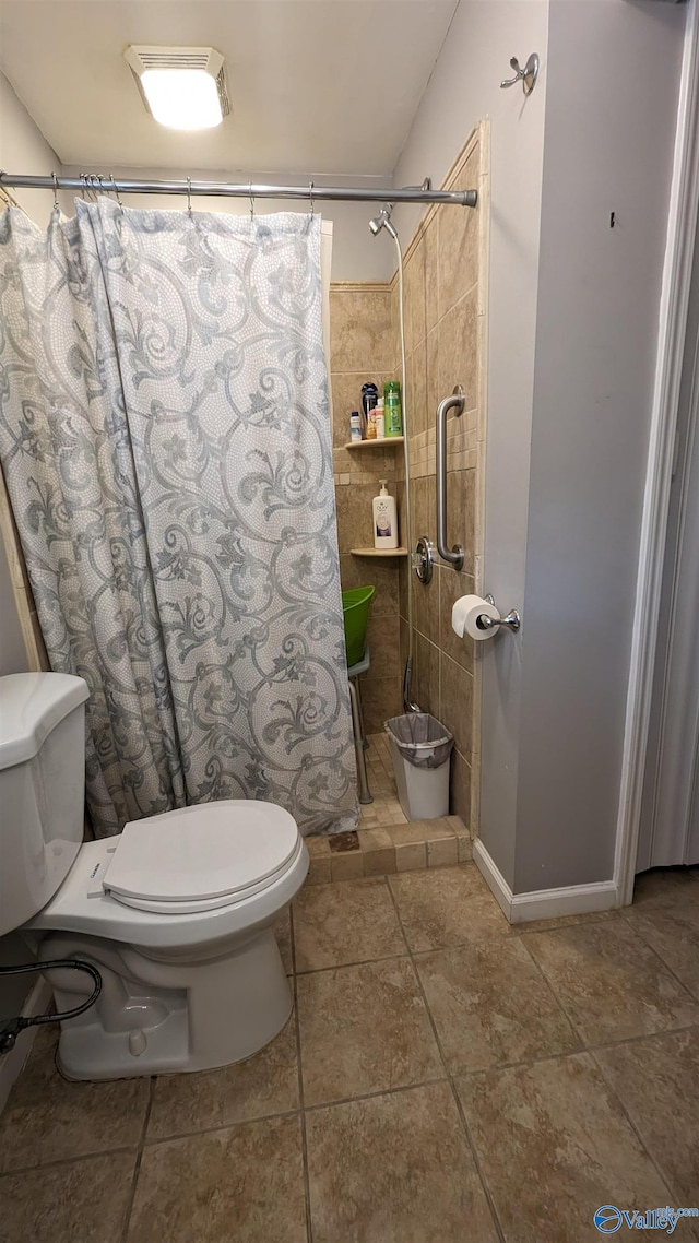 bathroom with tile patterned floors and toilet