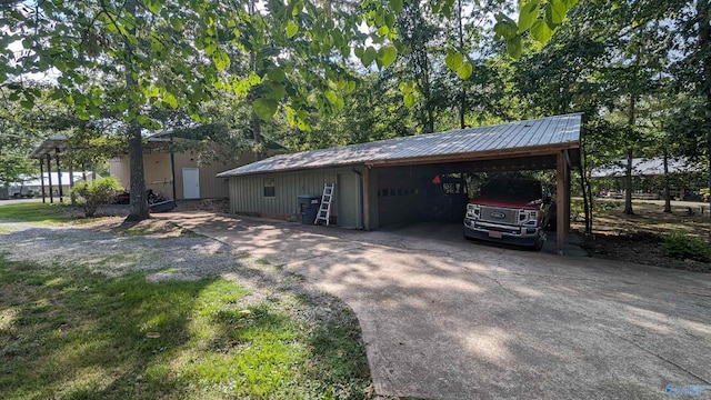 view of side of home with a carport, an outbuilding, and metal roof