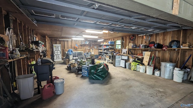 garage featuring wood walls and a workshop area