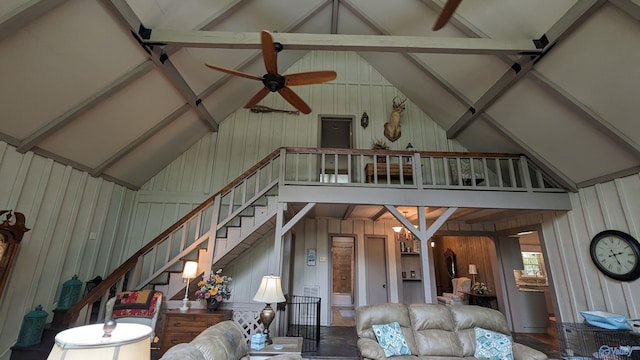 living room with ceiling fan, wood walls, and lofted ceiling