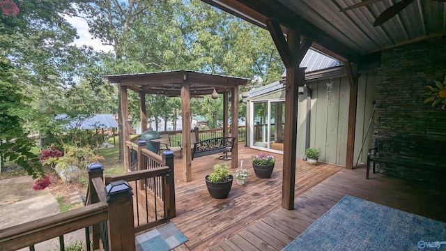 wooden deck with area for grilling and a gazebo