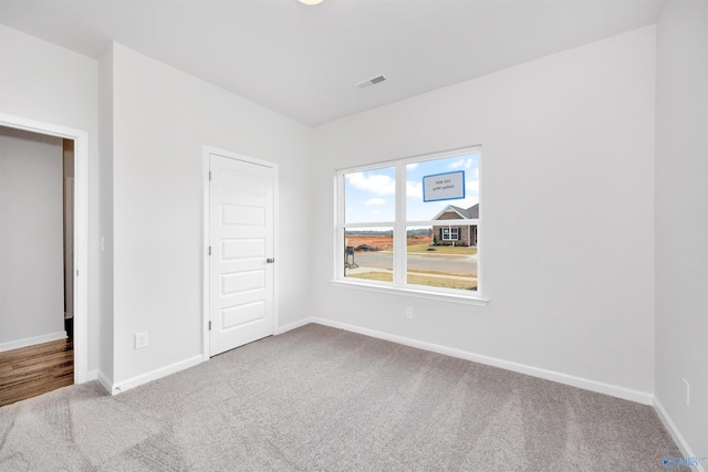 unfurnished bedroom with a closet and carpet flooring