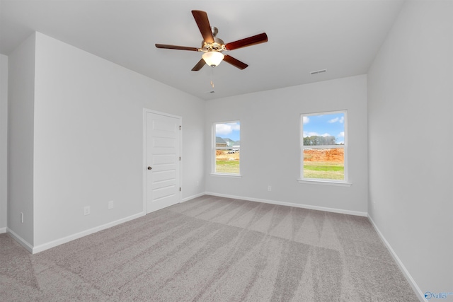 empty room with light colored carpet and ceiling fan