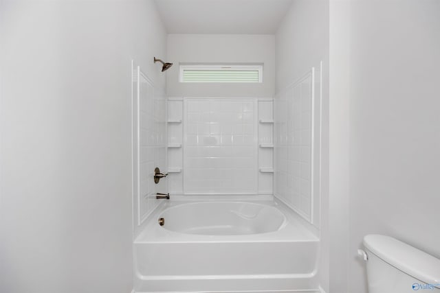 bathroom with bathing tub / shower combination and toilet