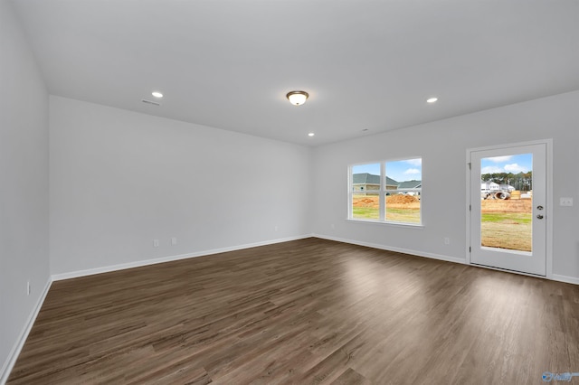 empty room with dark hardwood / wood-style flooring