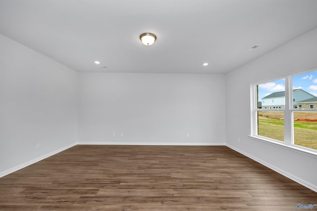 unfurnished room with dark wood-type flooring