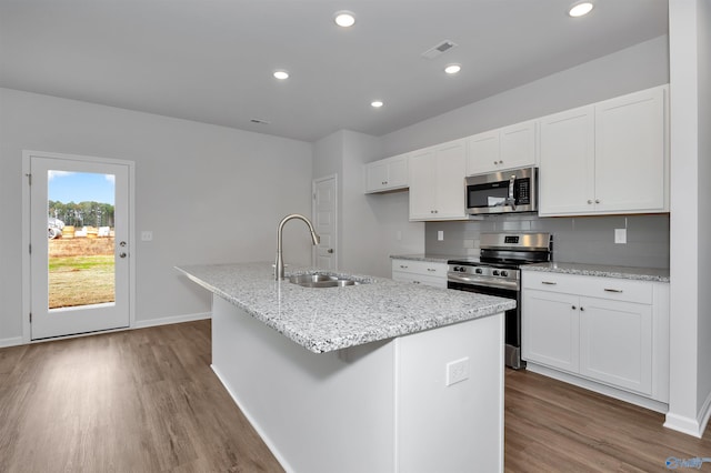 kitchen with white cabinetry, sink, an island with sink, and appliances with stainless steel finishes