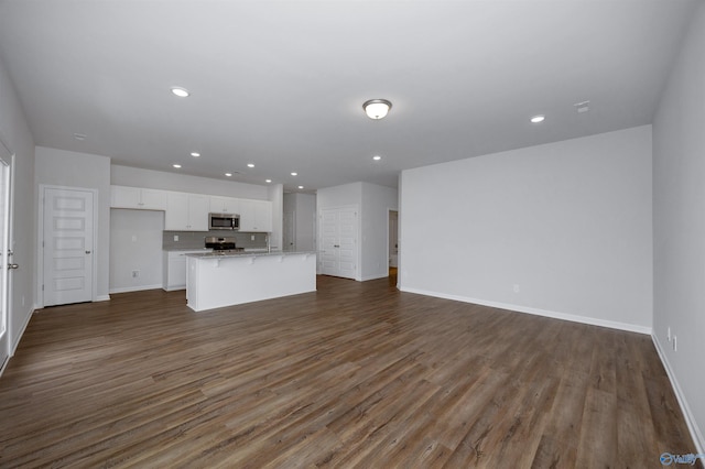 unfurnished living room with dark hardwood / wood-style floors