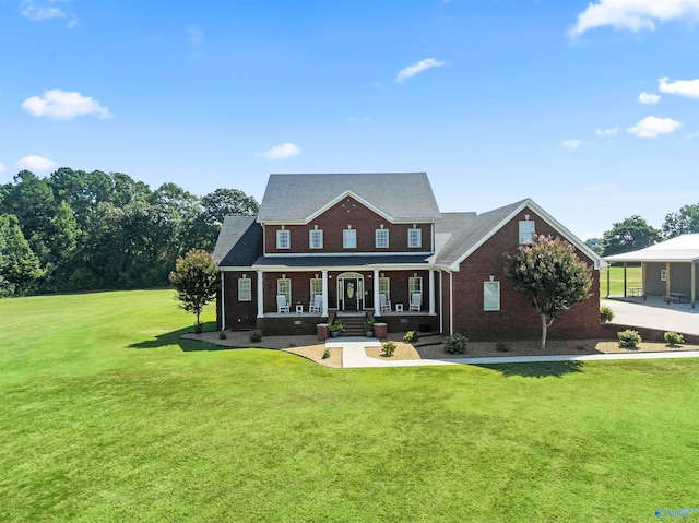 colonial home with a front yard and covered porch