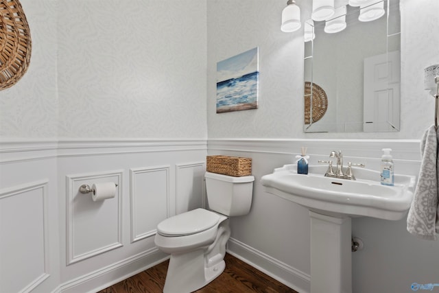 bathroom featuring toilet and wood-type flooring