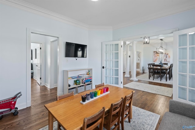 dining room with french doors, crown molding, ornate columns, and dark hardwood / wood-style floors