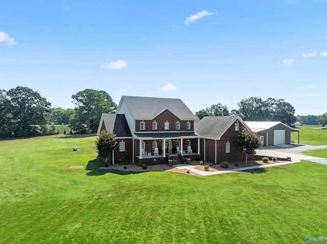 back of property with a yard, covered porch, and a garage