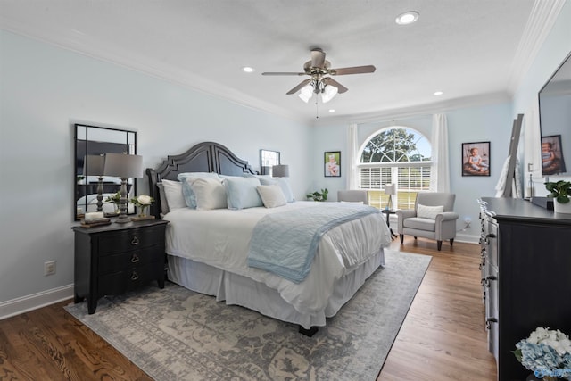 bedroom with ceiling fan, crown molding, and dark hardwood / wood-style floors