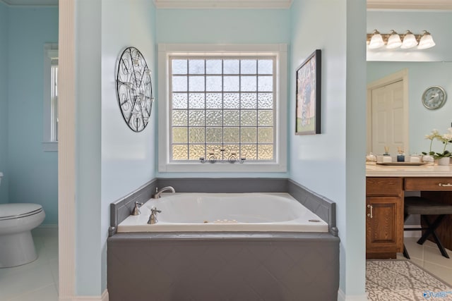 bathroom with vanity, toilet, tile patterned floors, and tiled tub