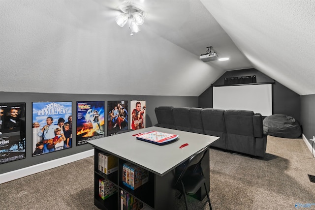 home theater room featuring dark carpet, vaulted ceiling, a textured ceiling, and ceiling fan