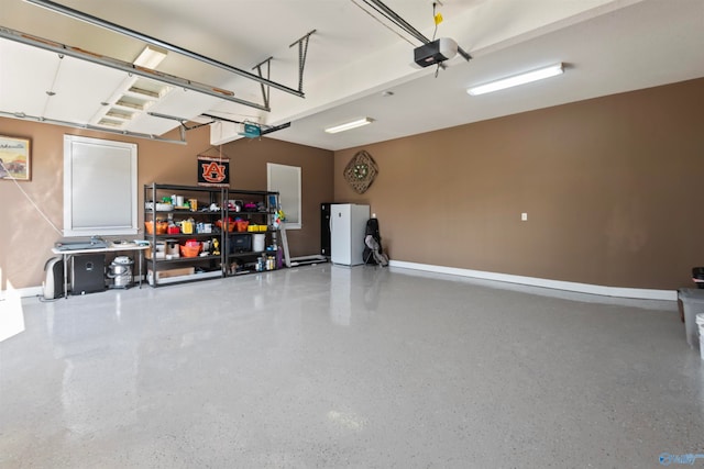 garage featuring a garage door opener and white refrigerator