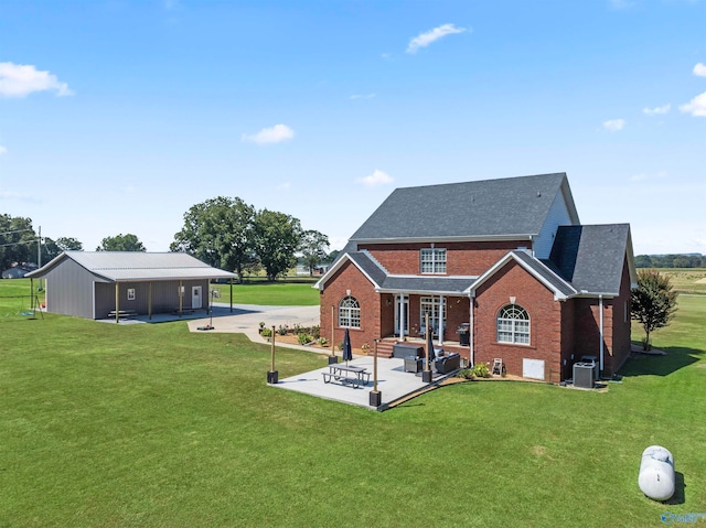 back of house featuring central air condition unit, a patio, and a lawn