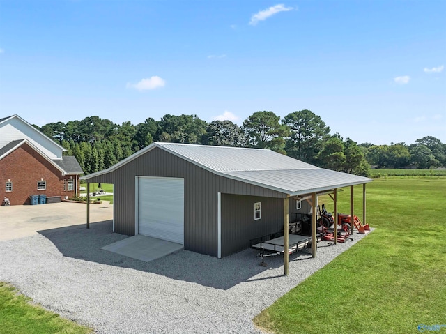 view of outbuilding featuring a garage and a lawn