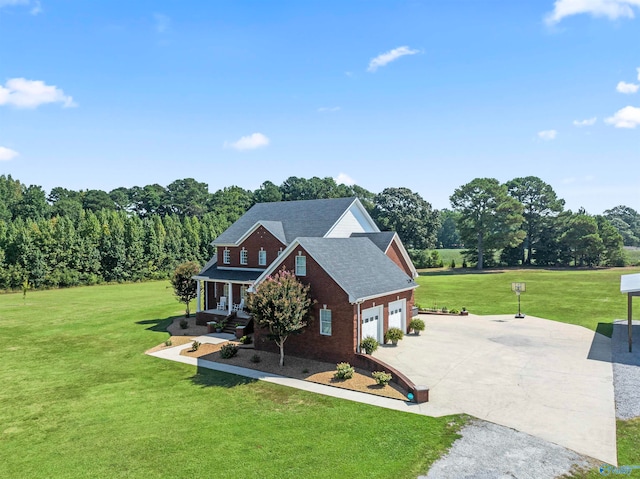 view of front of home featuring a porch, a front lawn, and a garage