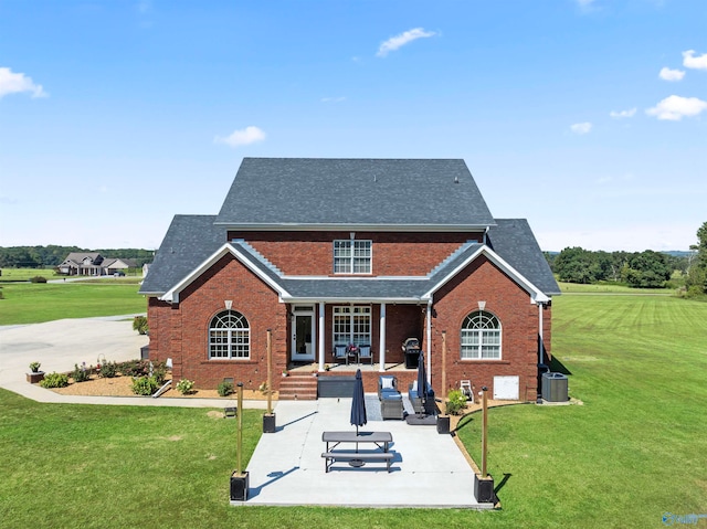 back of property featuring a yard, a patio, and cooling unit