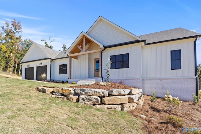 modern farmhouse style home featuring a garage and a front lawn