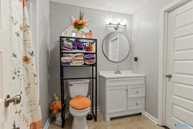 bathroom featuring toilet, vanity, and tile patterned floors