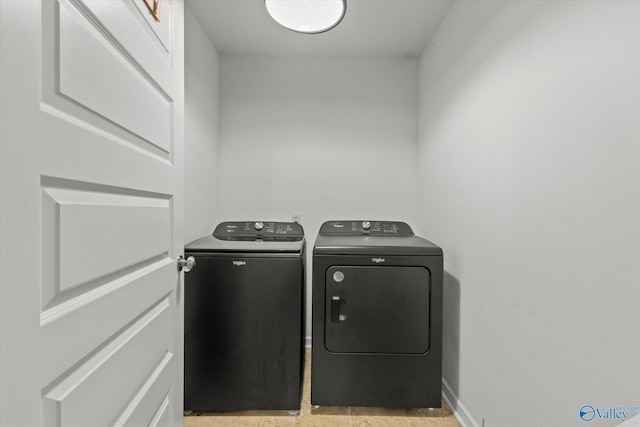 clothes washing area with washing machine and clothes dryer