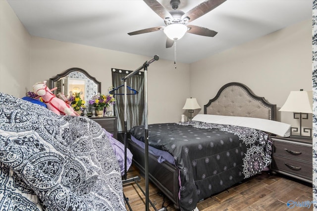 bedroom with ceiling fan and dark hardwood / wood-style flooring