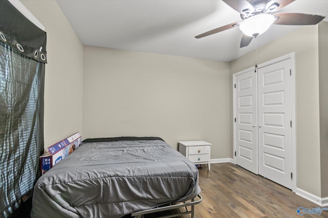 bedroom featuring ceiling fan, a closet, and dark hardwood / wood-style floors