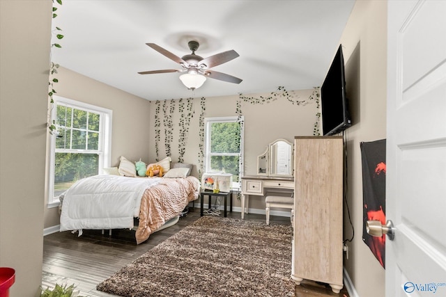 bedroom with ceiling fan and dark hardwood / wood-style flooring