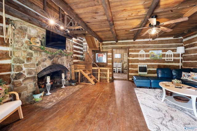 living area featuring heating unit, beam ceiling, hardwood / wood-style floors, ceiling fan, and wood ceiling