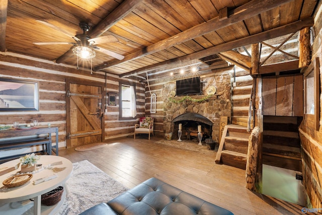 living room with wood walls, wood ceiling, hardwood / wood-style floors, and beamed ceiling